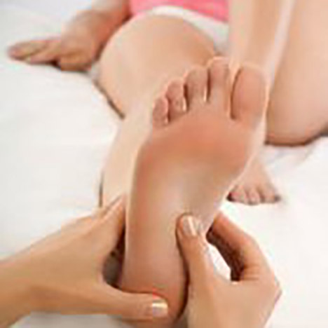 Woman receiving foot massage --- Image by © Marc Vuillermoz/Onoky/Corbis